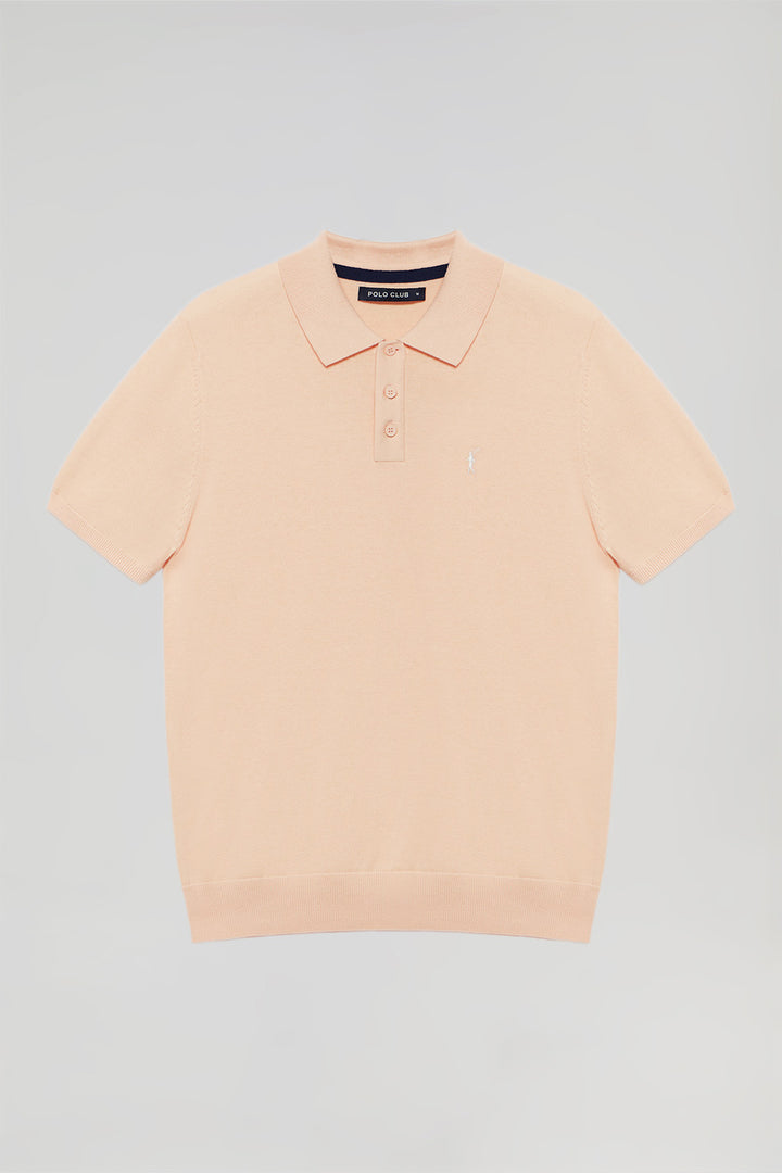 Peach knit polo shirt with Rigby Go embroidery