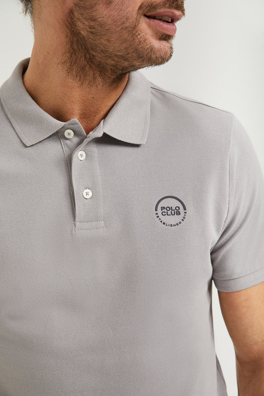 Grey pique polo shirt with three-button placket and gummed logo