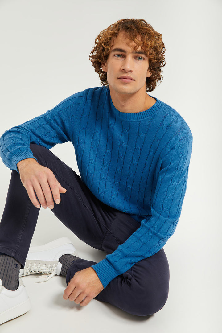 Jersey azul en punto de ochos con detalle en bajo
