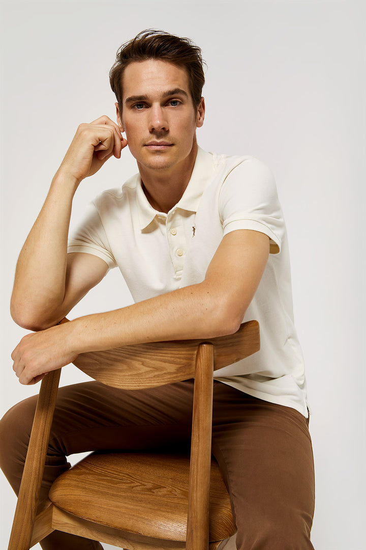 Beige pique polo shirt with three-button placket and contrast embroidered logo